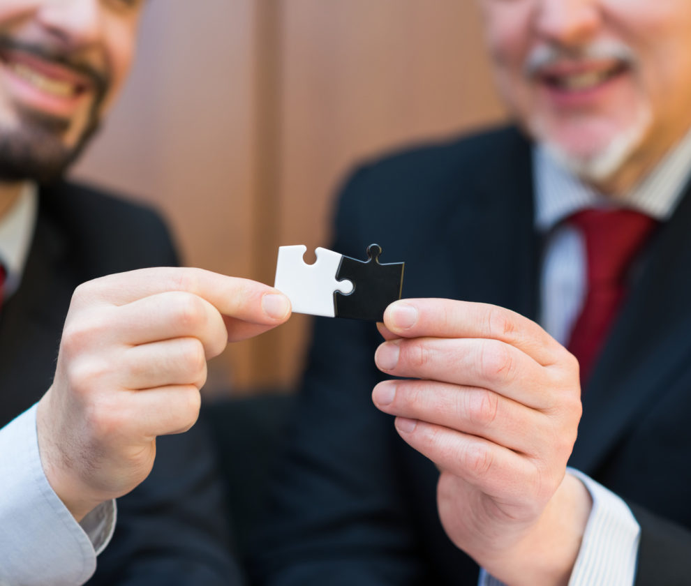 Business concept, businessmen putting puzzle pieces together